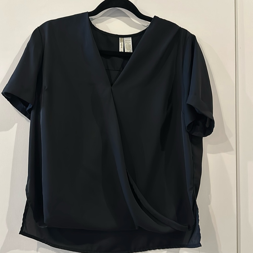 Size medium sheer (polyester) shirt with a material cross in the front.